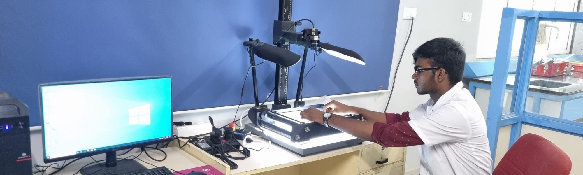 Student handling Leaf area meter in the Laboratory